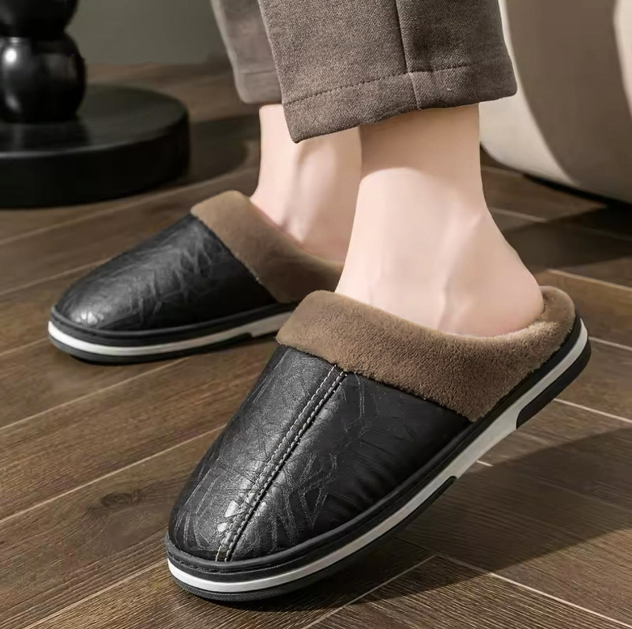 A person wearing brown faux leather half shoes with plush fur lining.