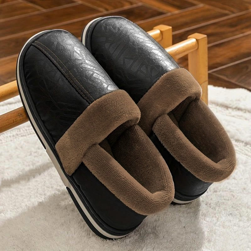 A pair of maroon faux leather slippers with plush brown fur lining on a wooden floor.