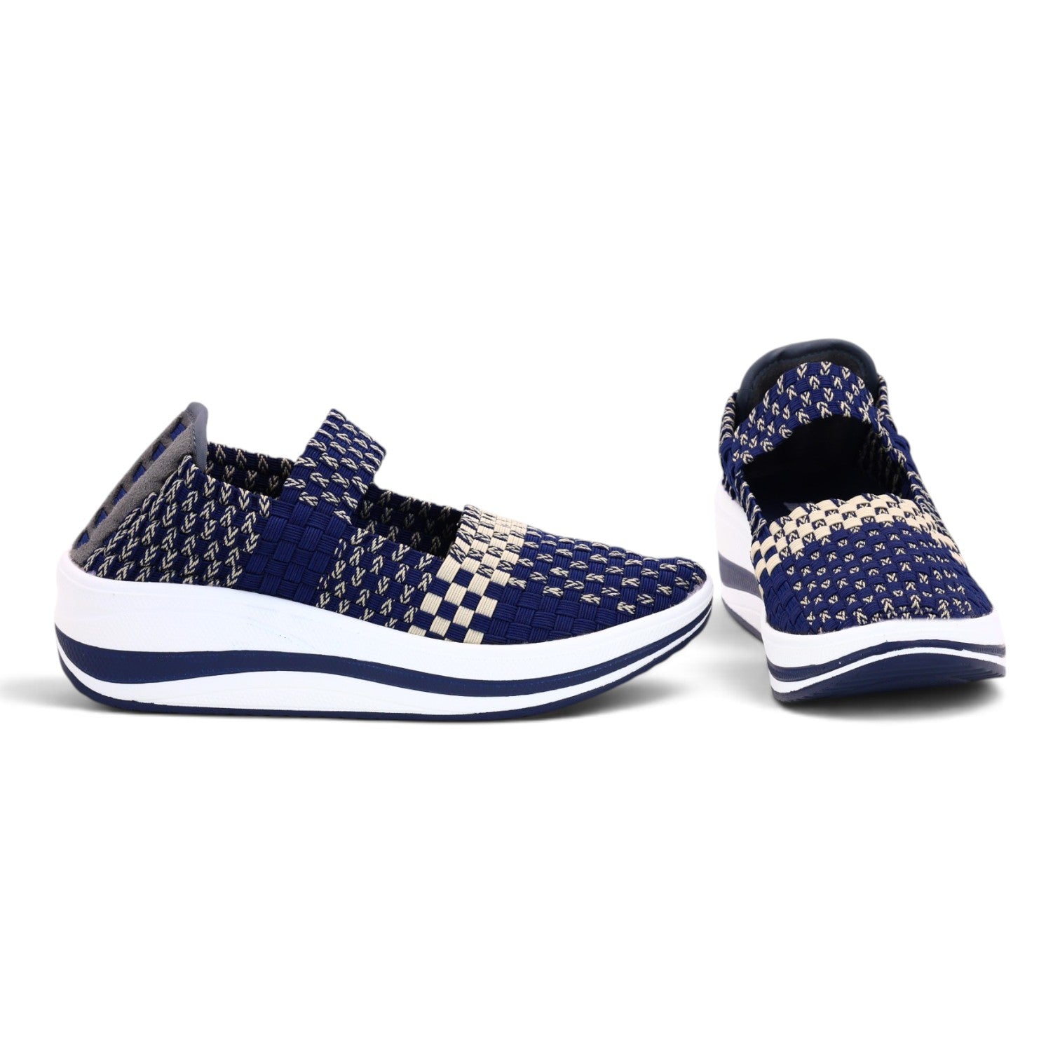 A pair of slip-on knit sneakers in navy blue and beige, featuring a checkered pattern and a thick white sole, shown against a plain white background.