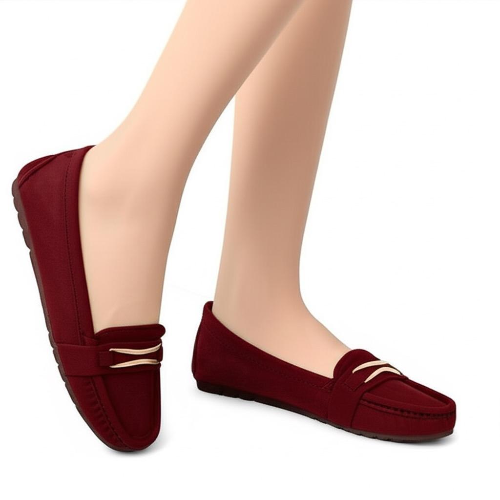 Red loafers worn on feet against a white background